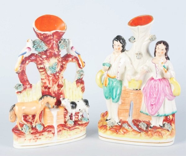 Lot of 2: Staffordshire Spill Vases.: One is titled "At the Wall" and the other is cow, horses and birds gathering at the well. Light paint loss and to the cole slaw. Condition (Good). Size Each: 10 - 1/2" T.