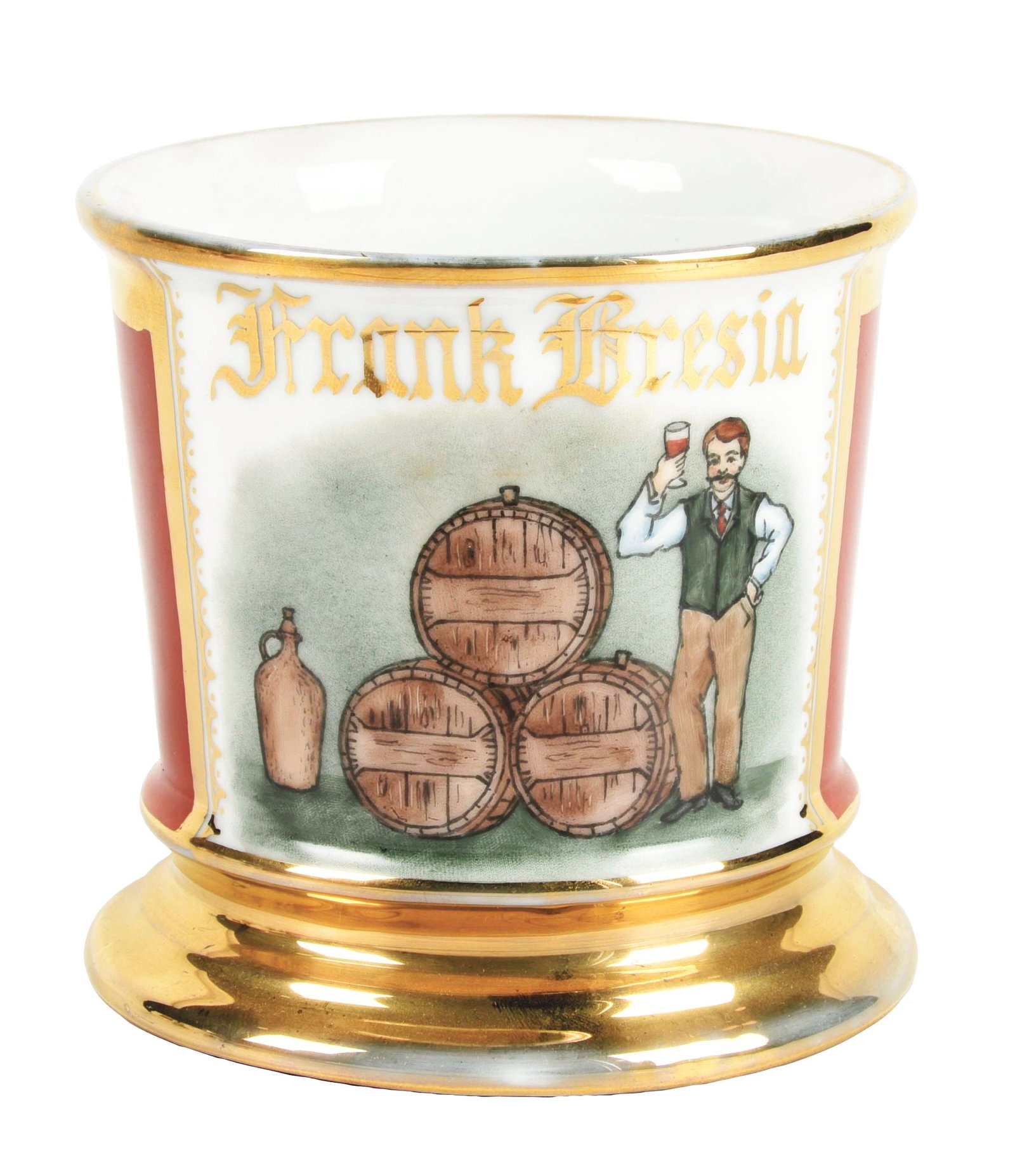 WINE PRODUCER SHAVING MUG: Has the name "Frank Bresin" in gold gilt. Maroon wrap. Nice image of man standing in front of wine barrels pouring a glass of wine. Condition: (Excellent) Item Dimensions: 4 - 1/2" x 3 - 3/4" x 3 - 1/
