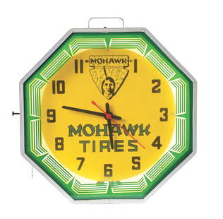 MOHAWK TIRES NEON CLOCK.: Maker Marked "Neon Products. Lima, Ohio." A desirable example of this neon clock from Mohawk Tires featuring a Native American graphic with neon lighting. CONDITION: The inner face of the clock remain