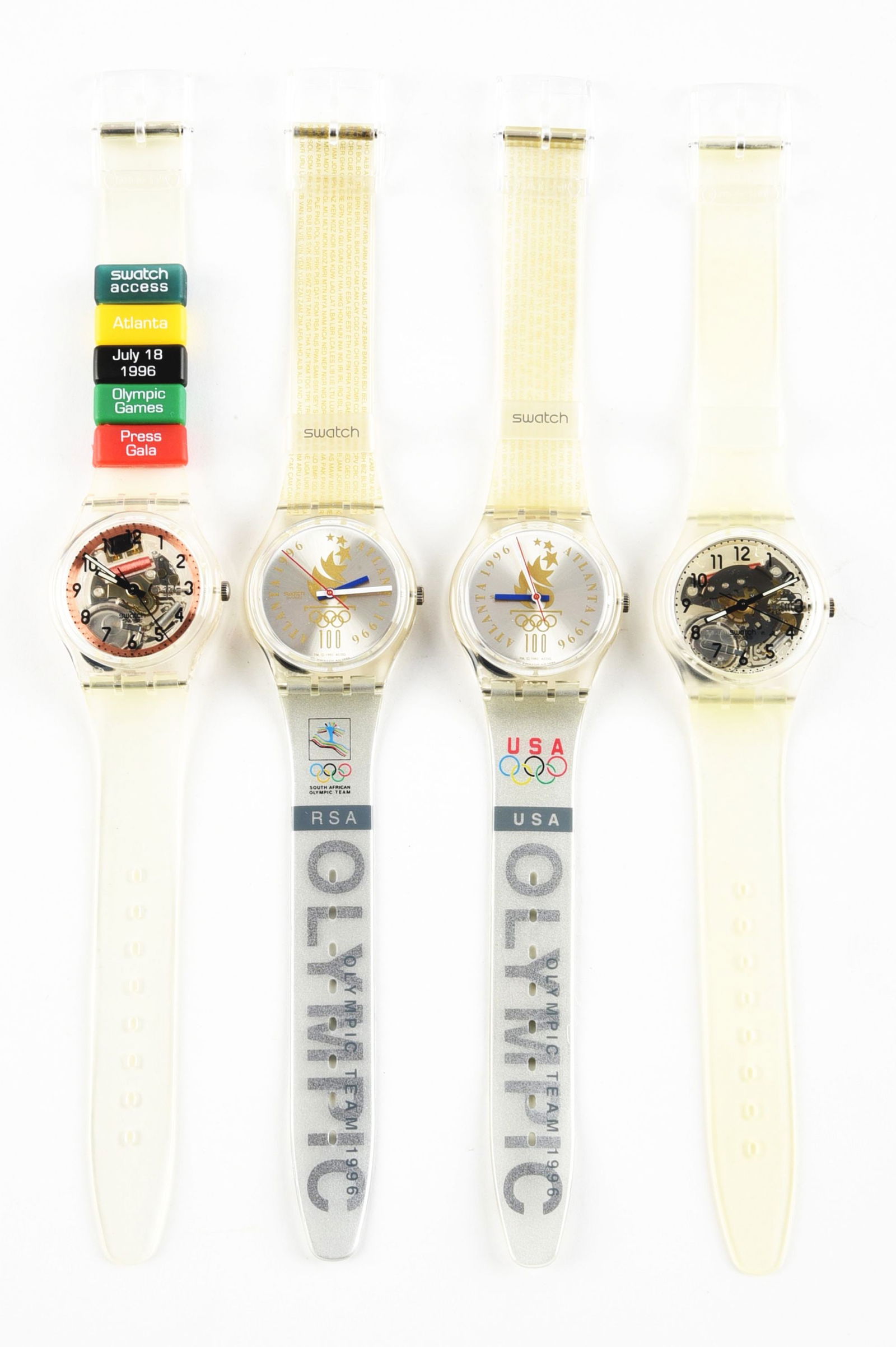 LOT OF 5: OLYMPIC SPECIALS SWATCHES: (A) SKK100C "Atlanta Press" Olympic Specials Swatch Watch. (B) GZ150B "Olympic Team RSA" Olympic Specials Swatch Watch. (C) GZ150J "Olympic Team USA" Olympic Specials Swatch Watch. (D) GK209SL "Transp