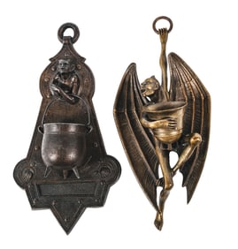 A PAIR OF BRONZE WALL HANGING MATCH HOLDERS