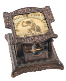 CAST IRON CLOCKWORK MATCH DISPENSER ADVERTISING ROCKY FORD CIGARS