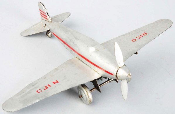 Tin Litho Rico Airplane Wind-Up Toy.: Spanish. Made pre and post-war. Working. Single engine fighter plane marked "Rico" and "N160" on wings. Some minor scratching and wear throughout with a few paint touchups to wing (in silver). Picture