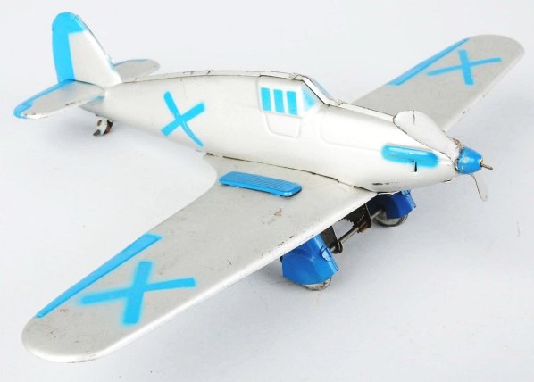 Tin Litho Rico Hurricane Fighter Airplane Toy.: Spanish. Made both pre and post-war. Wind-up mechanism is working. Has "X"s on both sides of wings and fuselage. This is a copy of an English fighter plane with some overall wear. From the collection