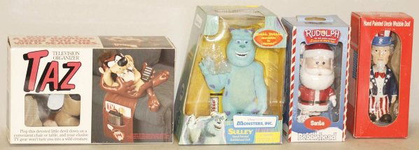 Lot of Assorted Character Toys in Boxes.: This lot includes a 2001 CORGI Green Hornet car Dr. Suess Lorax hand puppet, Monsters Inc. Sulley bobble head, and numerous other character toys. Condition (Excellent). Size Largest Box: 14" x 10".