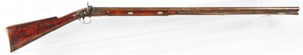 Philadelphia Single Barrel Shotgun by Jacob Koons: Overall length: 45 – ½”. Barrel length: 38 – ¾”. Half stock Kentucky-type curly maple rifle with half octagon half round .68 caliber barrel marked in script “Jacob Koons Philada.”. Brass