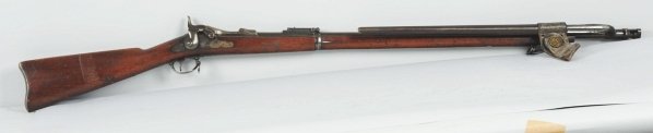 US Springfield Trapdoor Model 1884.: 45.70 caliber. Stock cartouche dated 1887, metal parts have smooth surfaces with bluing turning plum brown in some areas. Appears to be original oiled finish on stock with smooth surface, bayonet and 
