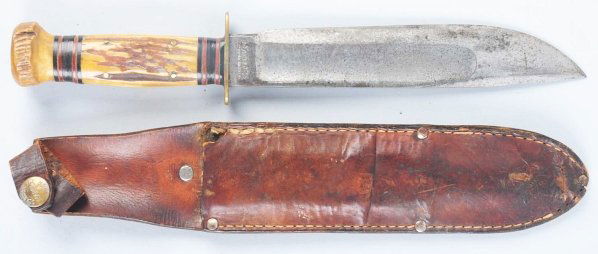 Marbles Gladstone "Ideal" Sheath Knife.: Stag crown on stag handle. Knife is in correct sheath with signed button. Condition (Very Good - Excellent). Size Blade: 7 - 7/8" L.