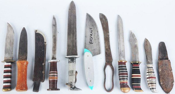 Lot of 9: Handmade Theate Knives (Most Unsigned).: Includes one dagger with blade marked "John Algor/Cast Steel" and all wood handle, one clip point sheath knife with brass mounts and handle composed of stacked black/red/white composite spacers altern
