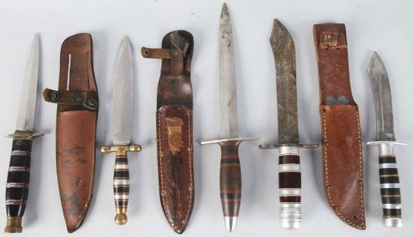Lot of 5: Unsigned Handmade Theater Knives.: Includes one dagger with brass mounts, handle composed of brass/aluminum/red composite/black composite spacers, and leather sheath. Next is a clip point sheath knife with aluminum mounts, handle compo