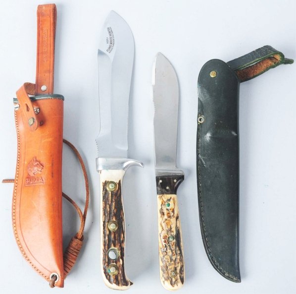 Lot of 2: Sheath Knives.: Includes one Puma "White Hunter" #6377 with aluminum guard marked "#96011", genuine stag handle, and leather sheath. Also includes one Puma "Forster-Nicker" sheath knife with horn finger guard, stag h