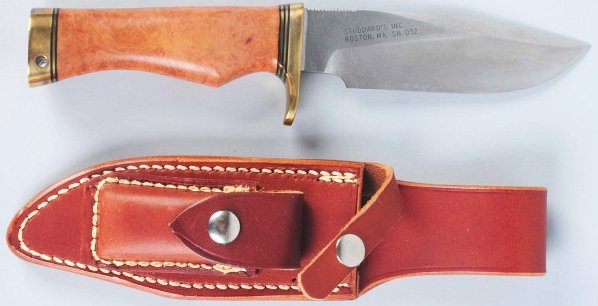 Randall Made Knife.: Marked "Orlanda FLA" on front and "Stoddard's Inc. Boston, MA" on back. Saber ground spear point blade. Handle is burl and fitted with a brass finger guard and butt cap drilled for lanyard hole. Corre