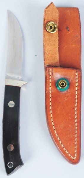 C.R. Sigman Knife.: Handle is black composite fitted with a nickel silver guard and oval shield inscribed with makers name. No butt cap. Correct sheath and original papers are included. Condition (Near Mint Plus). Size B