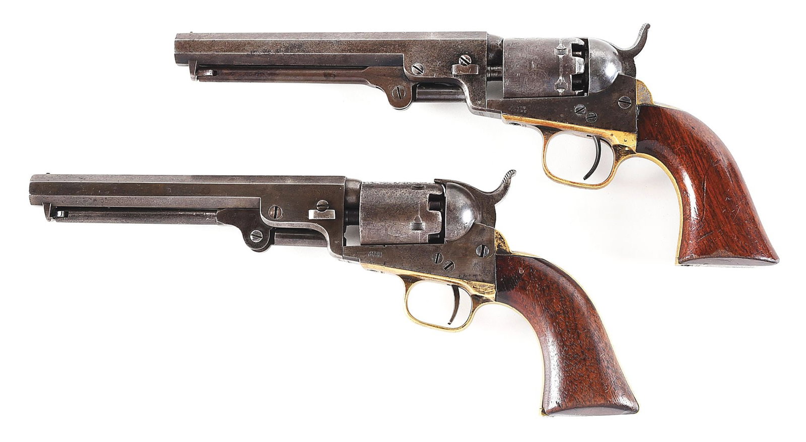 (A) RARE PAIR OF VERTICAL CASED COLT MODEL 1849 POCKET PERCUSSION REVOLVERS.: Gun (A) manufactured circa 1862 with desirable 6" octagon barrel, Hartford address, brass pin front sight, 6-shot cylinder, silver plate grip straps, and 1-piece varnished walnut grips. Gun (B) was ma
