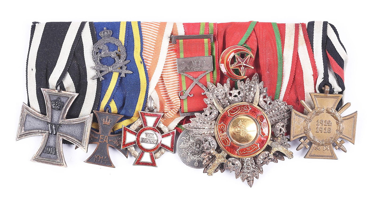 AUSTRO-HUNGARIAN WWI MEDAL BAR.: Austro-Hungarian World War 1 medal bar with a Imperial German 1914 2nd class Iron Cross and 1934 Hindenburg cross. The Hindenburg cross was added after the bar was assembled, and an extension was adde
