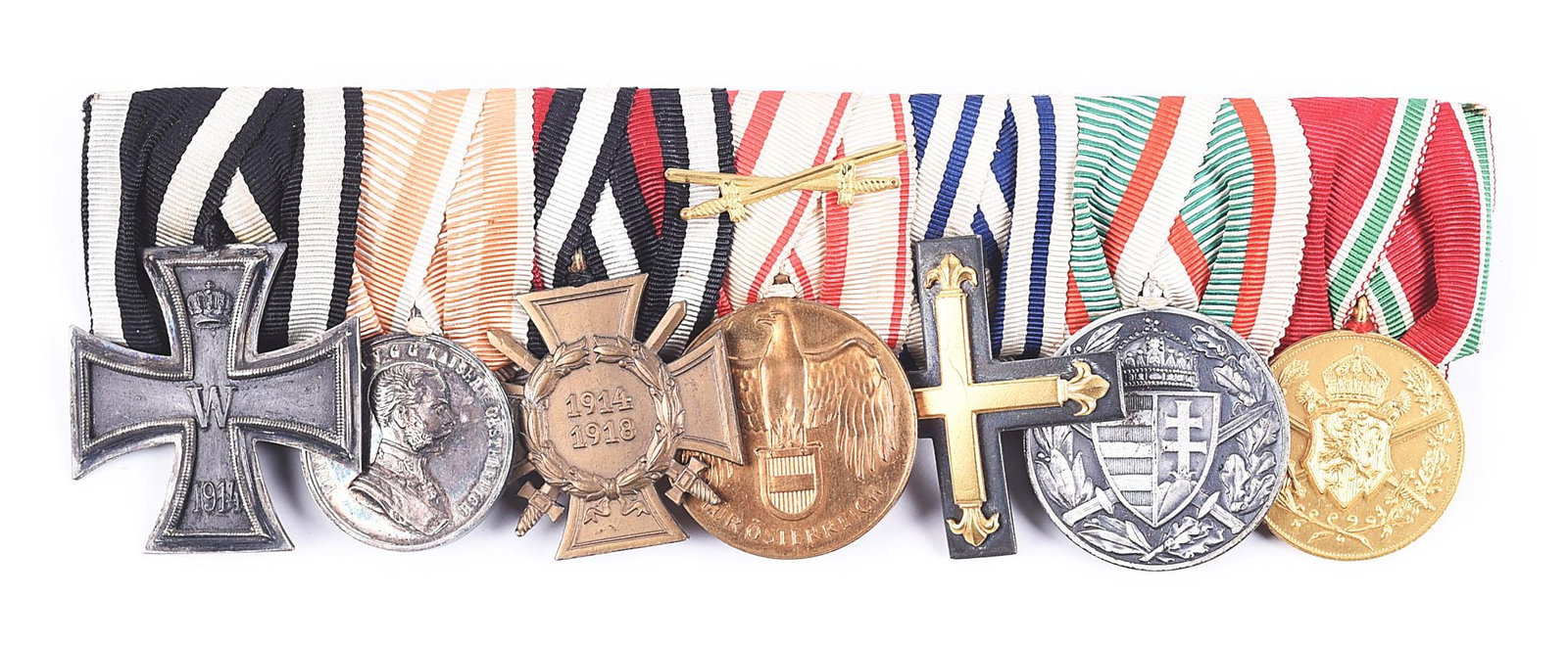 AUSTRO-HUNGARIAN WWI ULRICH MEDAL BAR.: World War I Austro-Hungarian medal bar with an Imperial German 1914 2nd class Iron Cross and a 1934 Hindenburg cross. The reverse has a tag attached for "C.G Ulrich, Hamburg", a well-known maker. COND