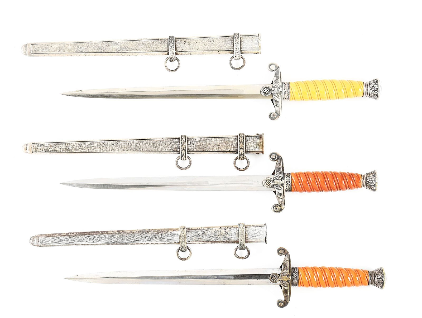 LOT OF 3: GERMAN WWII HEER DAGGERS.: Lot consists of (A) Heer dagger with "CARL EICKHORN SOLINGEN" marked blade with areas of visible cross graining, light runner, and scattered marks. Nickel silver plated fittings retain nice amounts of