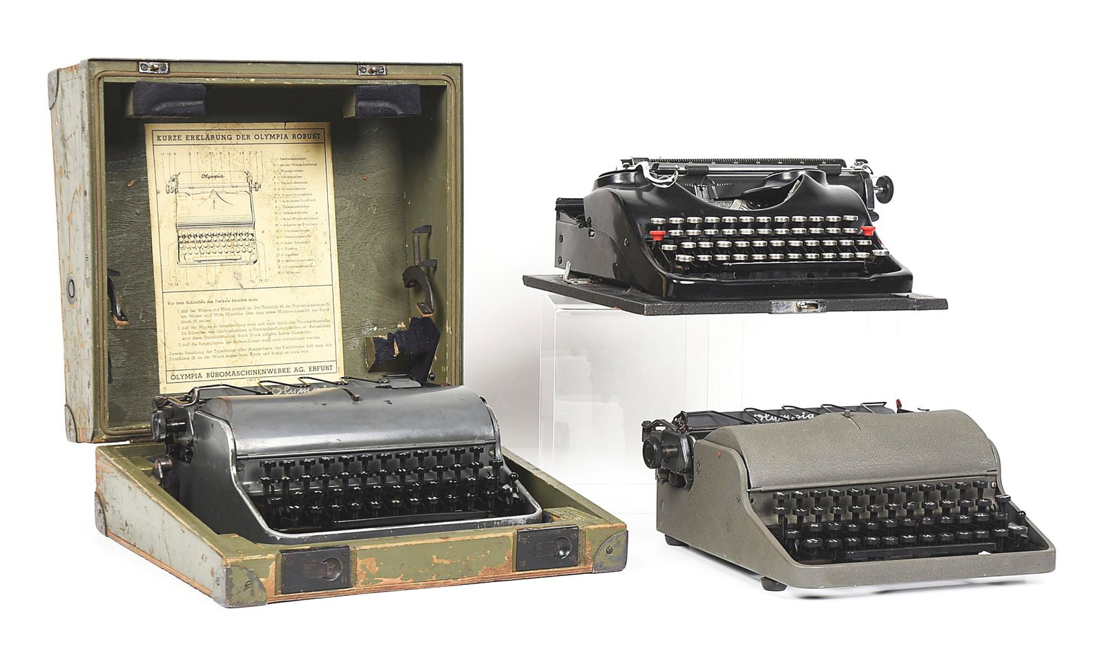 LOT OF 3: GERMAN WWII TYPEWRITERS.: Lot consists of: (A) German World War II Groma Model N typewriter with SS rune above the number 3 key. Functional with ink ribbon. Body intact with scattered blemishes. CONDITION: Good. (B) 1942 Olymp