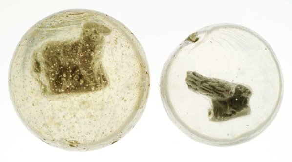 Lot of 2: Sulphide Marbles.: The smaller marble is a bird feeding figure with great detail and well-centered. The larger marble is a standing sheep figure with minor scuff marks and minor chipping. Condition (8.85 - 9.5). Size 1 