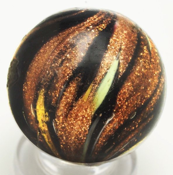 Indian Lutz Swirl Marble.: Black opaque base with white, red, green, yellow, and loaded with lutz. Surface has several chips and one large chip. This is a rare marble in any condition. Condition (8.5). Size 29/32"" Dia."