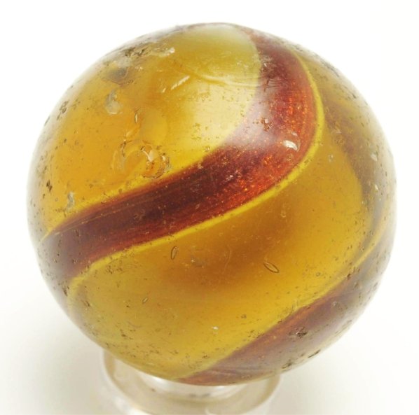Large Amber Glass Ribbon Lutz Marble.: Amber glass with white ribbon and nice, wide lutz bands. Marble has several surface chips. Condition (8.5 - 8.6). Size 1 - 3/8"" Dia."