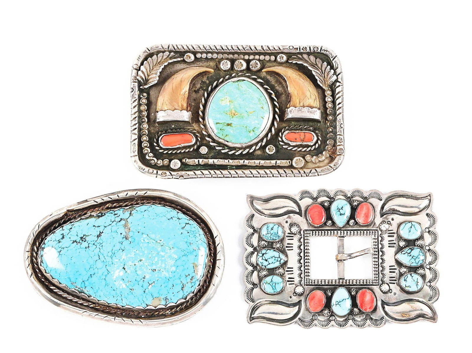 LOT OF 3 SOUTHWEST BELT BUCKLES: a) A rectangular buckle mounted with turquoise and coral stones, classic stamped Navajo designs by Bruce Morgan, 3 5/8" x 2 1/2"; b) A solid silver buckle with turquoise, coral and bear claw mountings