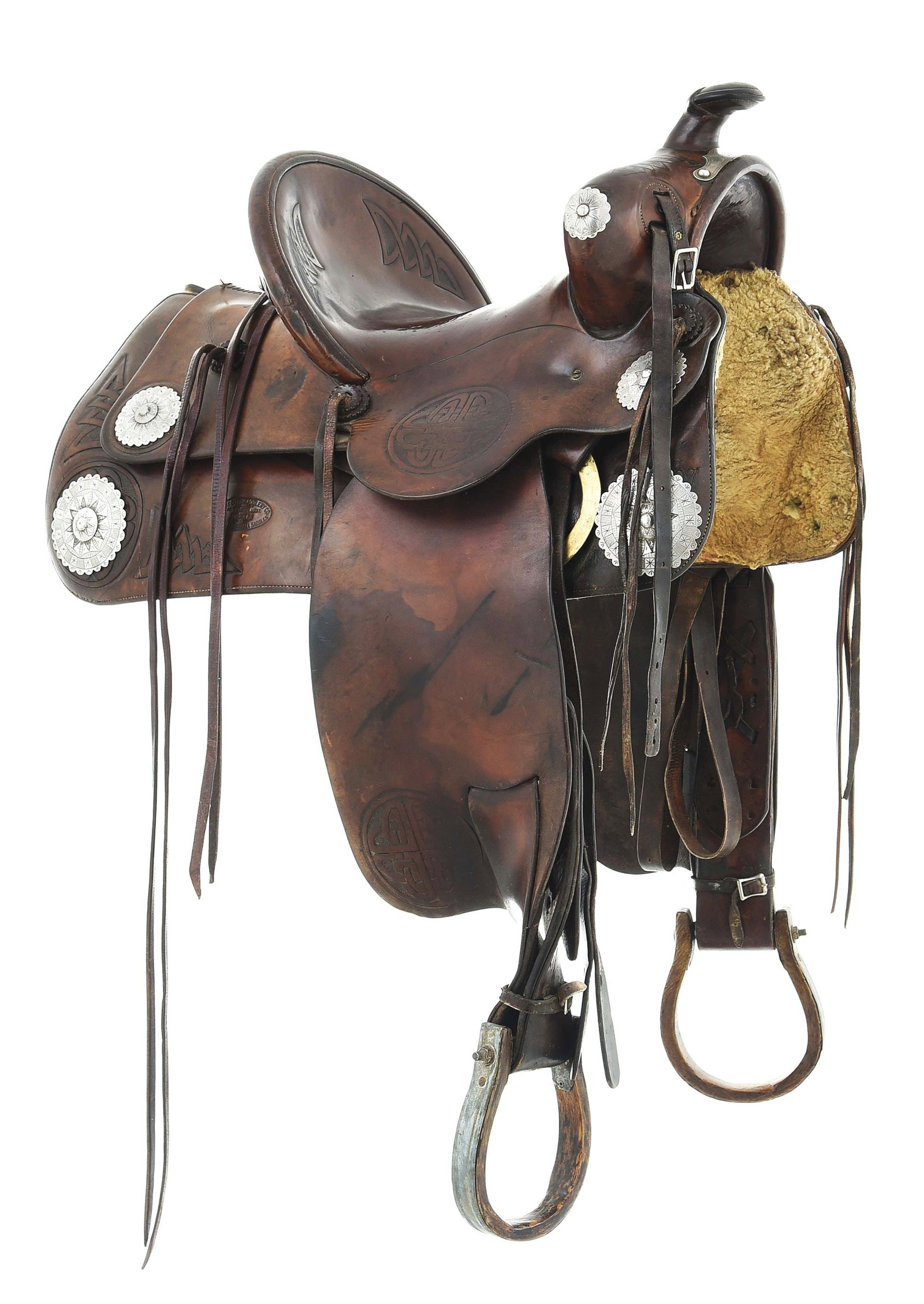 MILES CITY SADDLERY CO. SADDLE: A large square skirted and wide swelled stock saddle with added silver trim. Stamped #497 with the "Miles City Saddlery Co. / Miles City, Mont. / Makers / Original Coggshall Saddles" cartouche. The sa