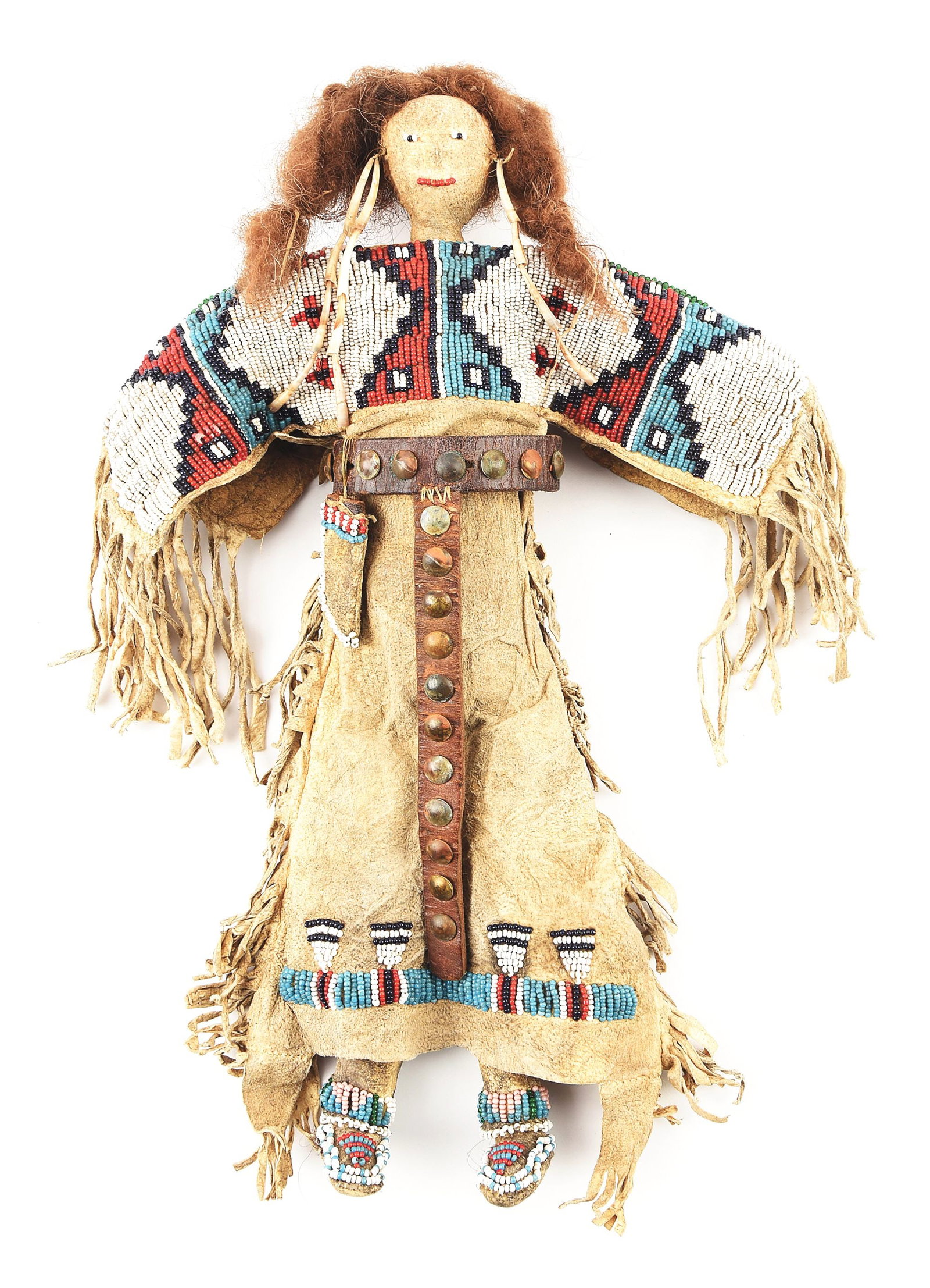 VINTAGE LAKOTA SIOUX BEADED HIDE FEMALE DOLL: Original beading decorated with a knife scabbard, moccasins and shawl, featuring shell adornment and fringed dress. Measures 13 1/2" tall x 9" wide at the widest point.