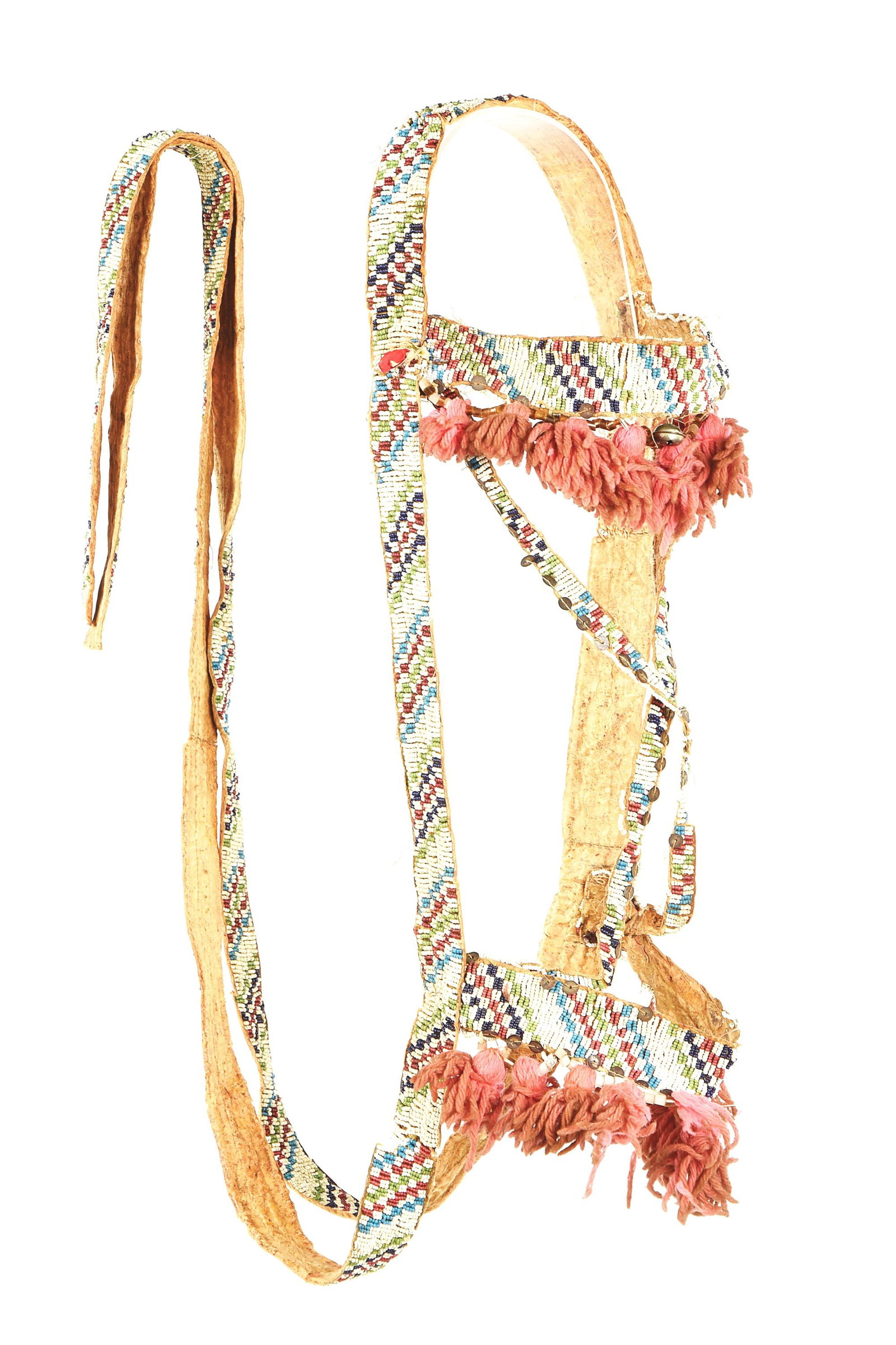 LAKOTA SIOUX BEADED BRIDLE: Lakota Sioux multi-colored beaded bridle on brain tanned buffalo hide. Stepped checkerboard design beaded flat bands throughout with X pattern face drop, cotton tassels and flat beaded reins.