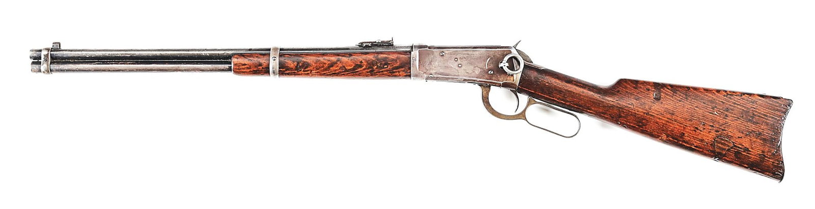 (C) WINCHESTER MODEL 1894 SADDLE RING CARBINE IN .25-35 WCF: SERIAL 574282. MFG. 1912. CALIBER 25-35. Standard full magazine, two-barrel bands, post front sight, folding ladder rear sight, blue finish, gumwood stocks, metal carbine butt plate, saddle ring & stu