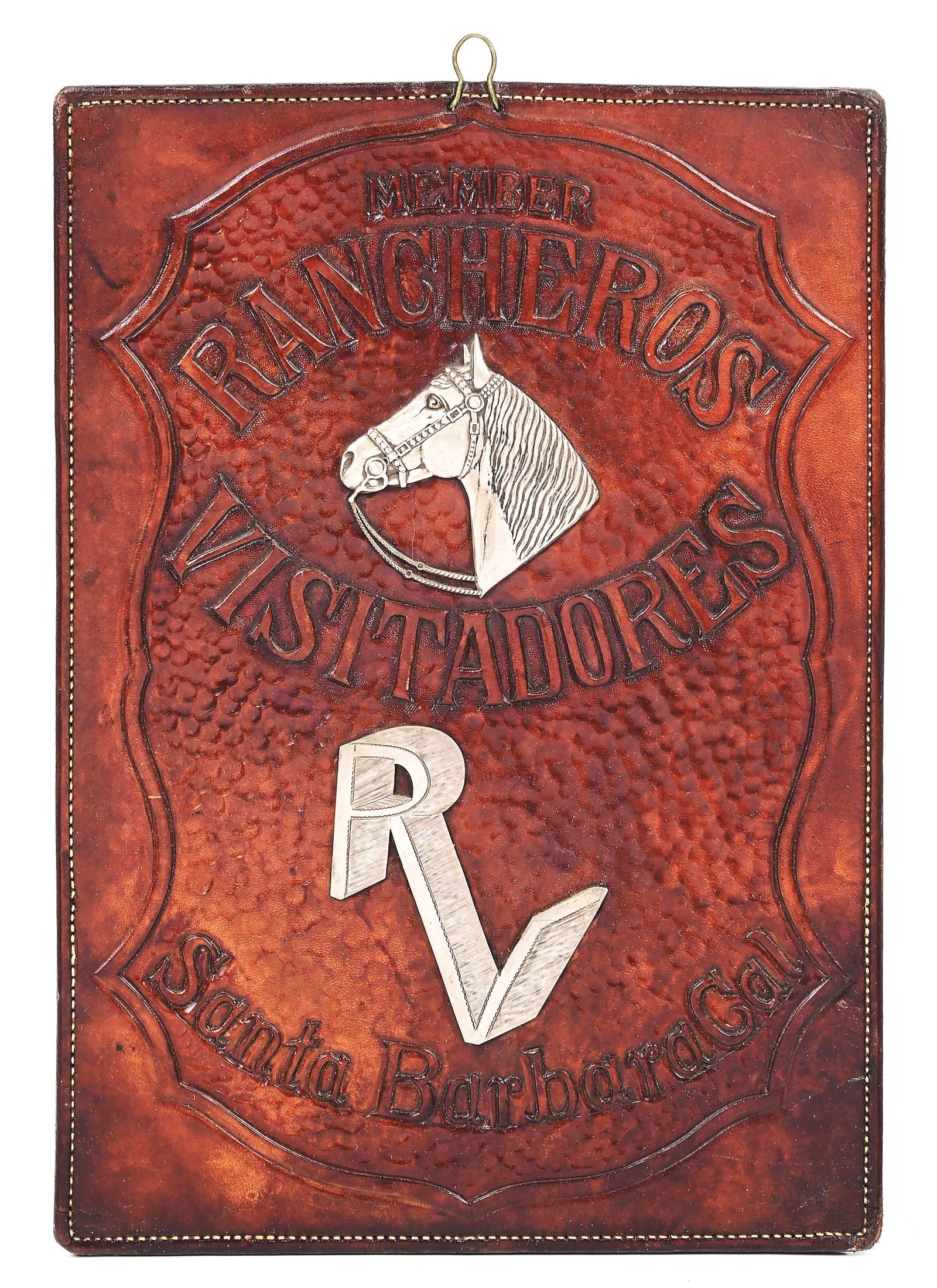 RANCHEROS VISITADORES LEATHER PLAQUE: Carved and stamped on leather with a sterling silver horse head, "RV" logo, "RANCHEROS VISITADORES" and "Santa Barbara, Cal", this distinctive early 1930s California plaque commemorates the illustriou