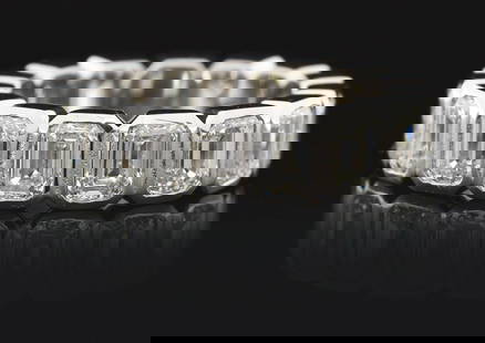 LADIES' PLATINUM 5CT EMERALD CUT DIAMOND ETERNITY BAND: Ladies' platinum and diamond eternity band consisting of 15 bezel-set emerald cut natural diamonds with a total weight of 5.00cts, graded H/I color, VS clarity. Finger size 6 1/4. Width 5.5mm. Gross