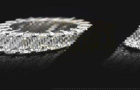 LADIES' PLATINUM 6.70CT EMERALD CUT DIAMOND ETERNITY BAND: Ladies' platinum and diamond eternity band consisting of 19 prong-set emerald cut natural diamonds with a total weight of 6.70cts, graded H/I color, VS clarity. Finger size 6 1/4. Width 5.25mm. Gross