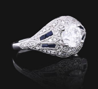 LADIES' PLATINUM DIAMOND & SAPPHIRE RING W/ REPORT: Ladies' platinum custom made diamond and sapphire ring consisting of 1 round brilliant cut natural diamond weighing 0.97cts, graded G color, SI2 clarity, and 0.13cts total weight in pave set round