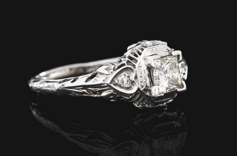 18K WHITE GOLD PRINCESS CUT DIAMOND RING W/ REPORT: Ladies' vintage style 18k white gold and diamond engagement ring consisting of 1 princess cut natural diamond weighing 0.52cts graded is L color, I1 clarity, and 2 round single cut natural diamonds