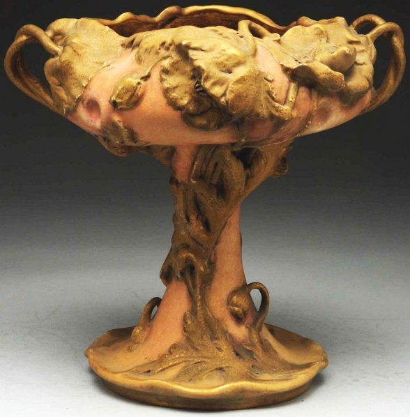 Footed Amphora Floral Compote.: With two floral handles. Amphora crown mark, Amphora oval mark, and Austria oval mark on underside. Condition (Mint). Size 11 - 1/2" T.