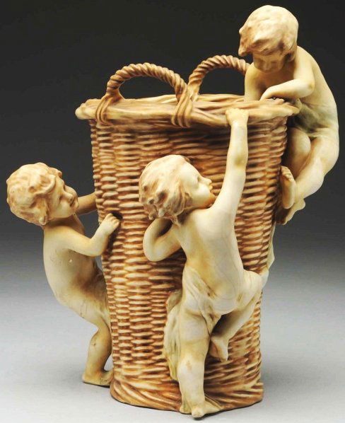 Amphora Ceramic Basket Weave Vase.: Children climbing the vase. Austria oval mark and Amphora crown mark to underside. Condition (Mint). Size 13" T.
