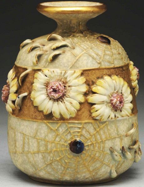 Amphora Daisy Vase.: With applied daisies, spider webs, and enameled jewels. Impressed Amphora mark, Austria mark, and Amphora crown mark on underside. Condition (Mint). Size 7 - 1/2" T.