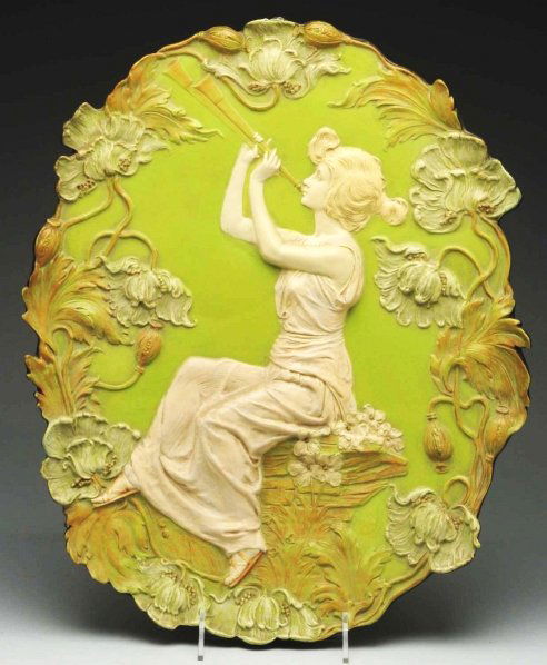 Amphora Oval Wall Plaque.: Depicting lady playing instrument. Made in Austria by Ernst Wahliss. Condition (Excellent). Size 20 - 1/2" T.