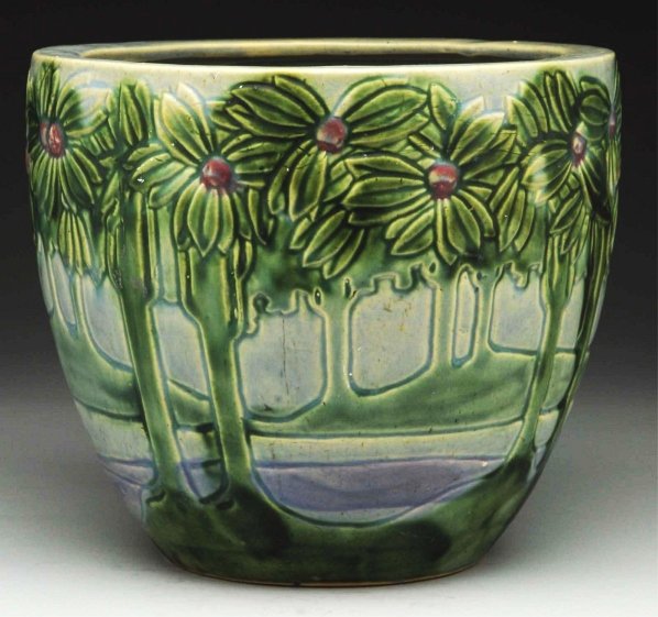 Roseville Vista/Forest Jardiniere.: Excellent colors and mold. Two very fine, tight shorts lines at rim. One small glaze chip in inner rim. Condition (Good). Size 9 - 1/2" T.
