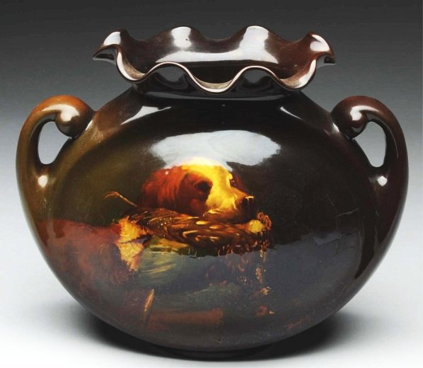 Rozane Ware Brown Glazed Pottery Vase.: With dog and pheasant. Double-handled. Some large chips to one ruffle at top. Artist signed "Dunlany". Condition (Very Good). Size 9" T.