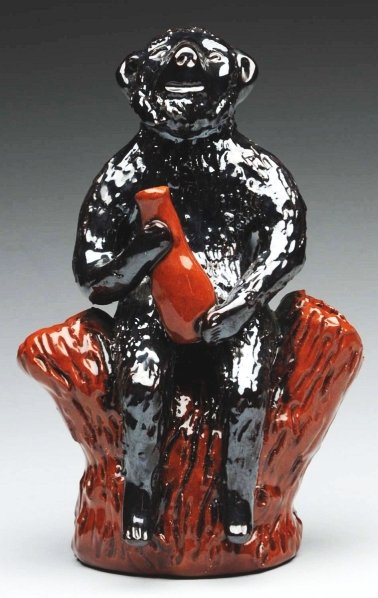 Unusual Lester Breininger Figural.: Depicts a monkey man holding a bottle and sitting on a stump. Condition (Excellent). Size 6 - 1/2" T.