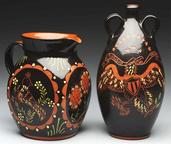 Pair of Lester Breininger Redware Items.: Includes one oversized milk pitcher with original bird and floral slipper decoration. Also includes one double handled bottle retaining the original incised spread wing eagle and floral decoration. Co