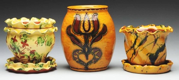 Lot of 3: Lester Breininger Redware Pottery Items: Includes one vase with tulip and heart decoration and one pair of redware flower pots. Condition (Excellent). Size Largest: 7" T.