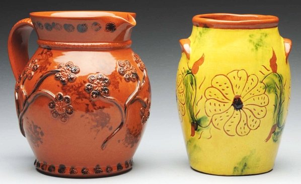 Pair of Lester Breininger Redware Examples.: Includes one very early, dated 1975, redware jar with incised floral decorations. Also includes one redware pitcher with applied floral decoration. Condition (Excellent). Size Each: 7 - 1/4" T.