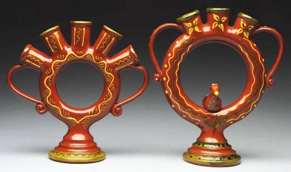 Pair of Lester Breininger Figural Vases.: Includes one with original handles and a bird inside of the wreath. Also includes one that is highly decorated in yellow and green slip with original scroll handles. Condition (Good - Excellent). Size