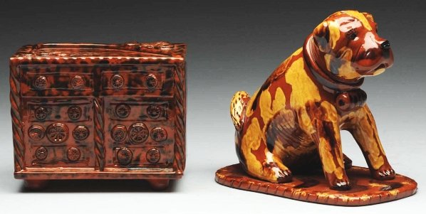 Lot of 2: Lester Breininger Figural Pottery.: Includes one of a seated dog bank attached to an incised base and one figural dresser bank with applied florals on front and top. Condition (Excellent). Size Largest: 6 - 1/4" T.
