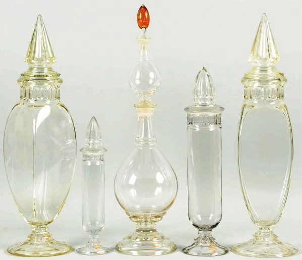 Lot of 5: Apothecary Candy Jars.: Three with ground lids and two non-ground. Includes a pair of four-sided jars, two cylinders, and one with four pieces. Condition (Excellent). Size Largest: 26 - 3/4" T.