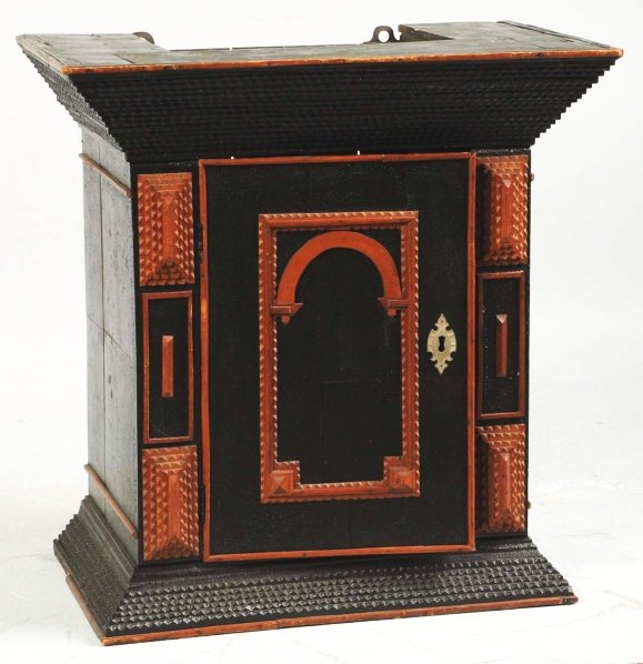 Extremely Rare Tramp Art Hanging Wall Cupboard.: 19th century. Single door construction. Great Pennsylvania German form. Outstanding original condition and retains a wonderful dark black surface. Condition (Excellent). Size 24" x 23 - 1/2".