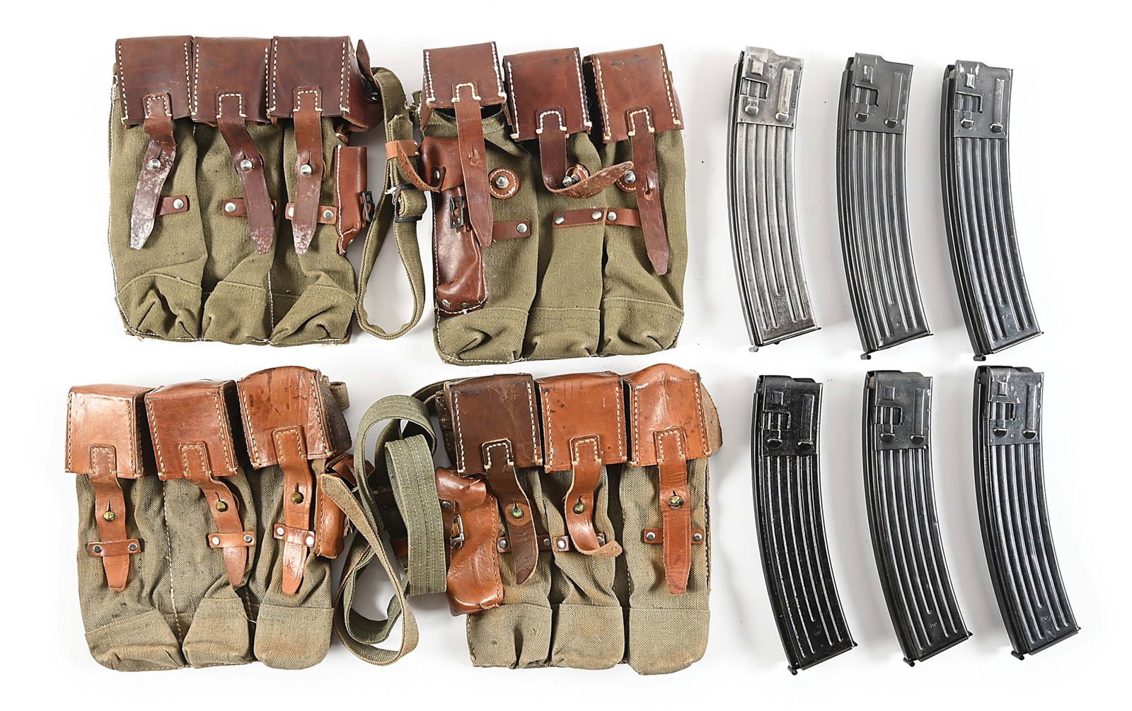 SIX ORIGINAL GERMAN MP-44 MACHINE GUN MAGAZINES WITH TWO SETS OF REPRODUCTION MAGAZINE POUCHES.: Lot consists of six original 30-round “MP-44” marked magazines with two pairs of reproduction magazine pouches. One set of pouches is clearly in near new condition, while the other set has
